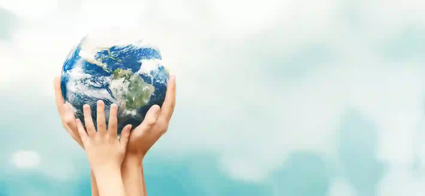 Hands holding a globe symbolizing global unity and care for the planet.