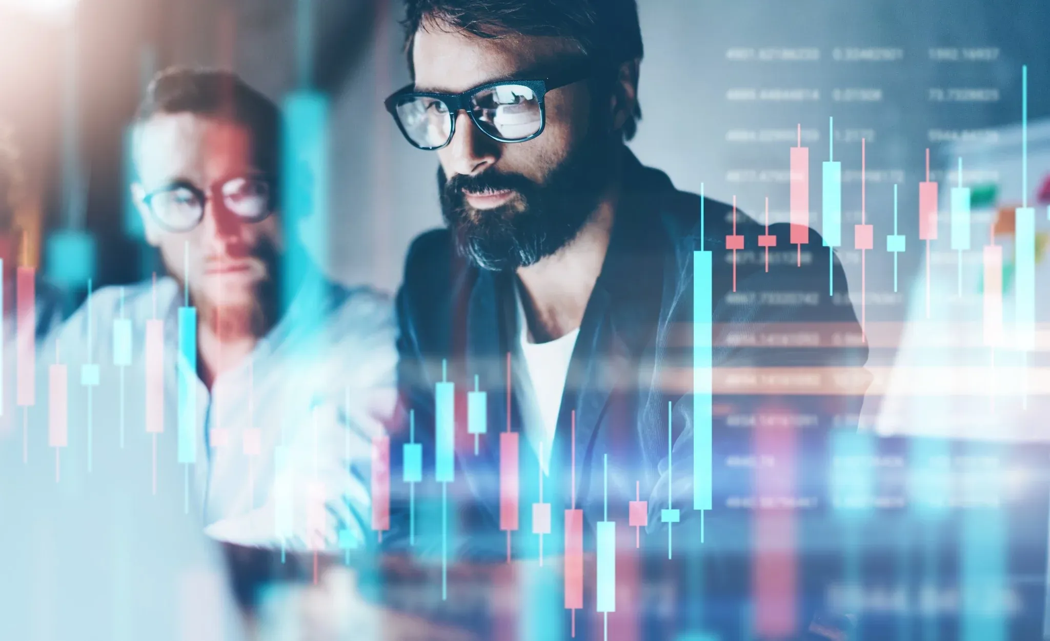 Professionals analyzing financial data with digital charts on screen.