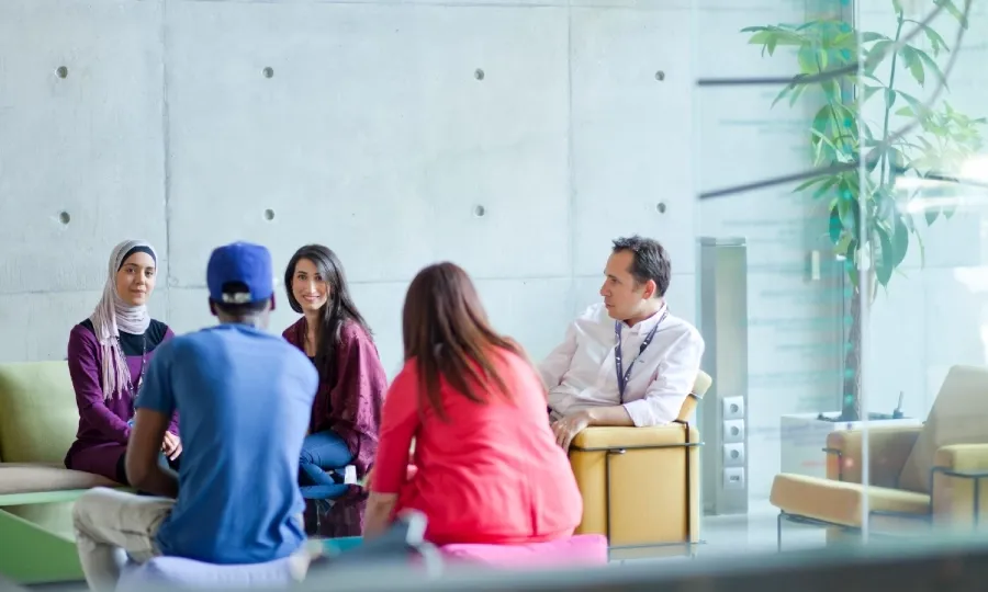 Diverse team collaborating in a casual meeting space.