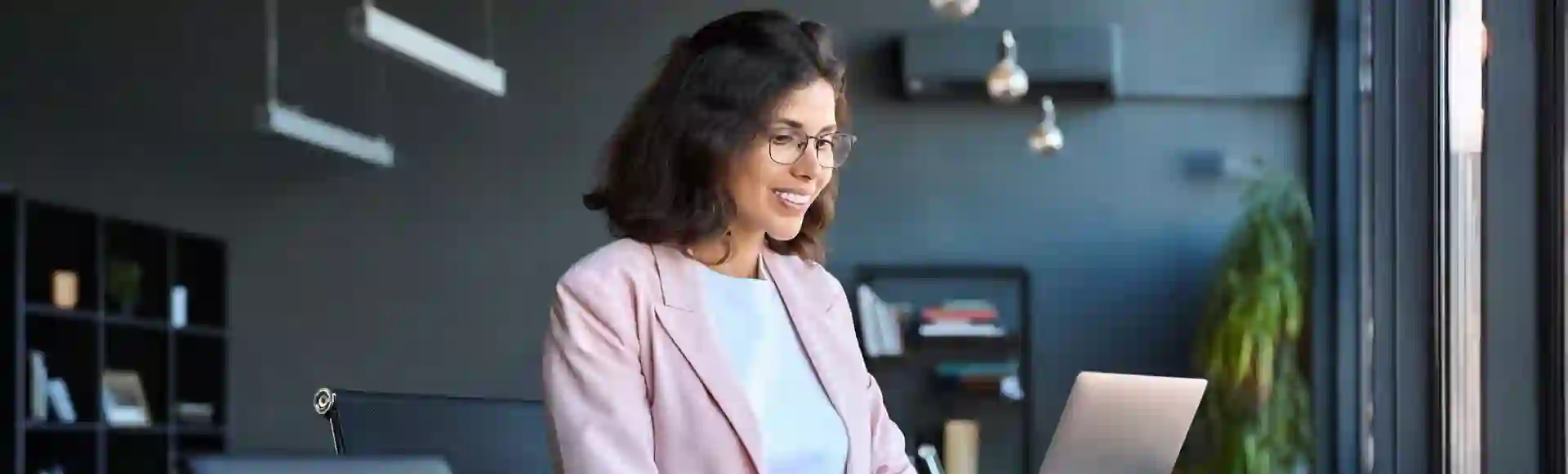 Smiling business woman working on her laptop
