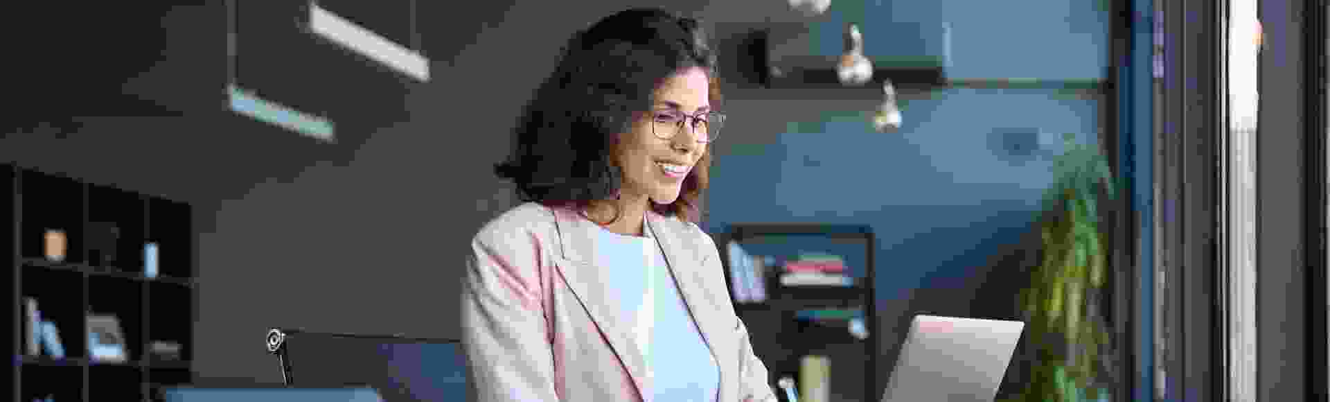 Smiling business woman working on her laptop