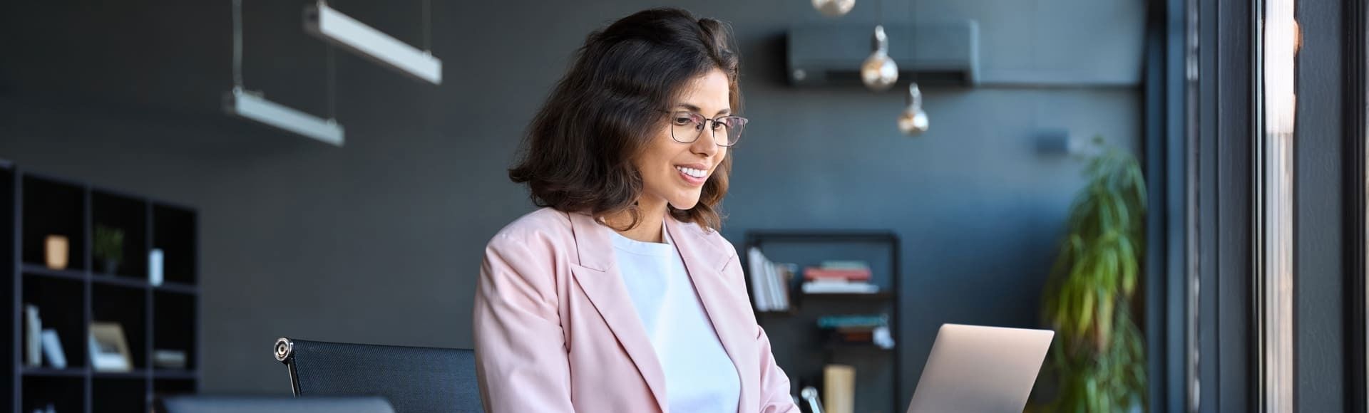 Smiling business woman working on her laptop