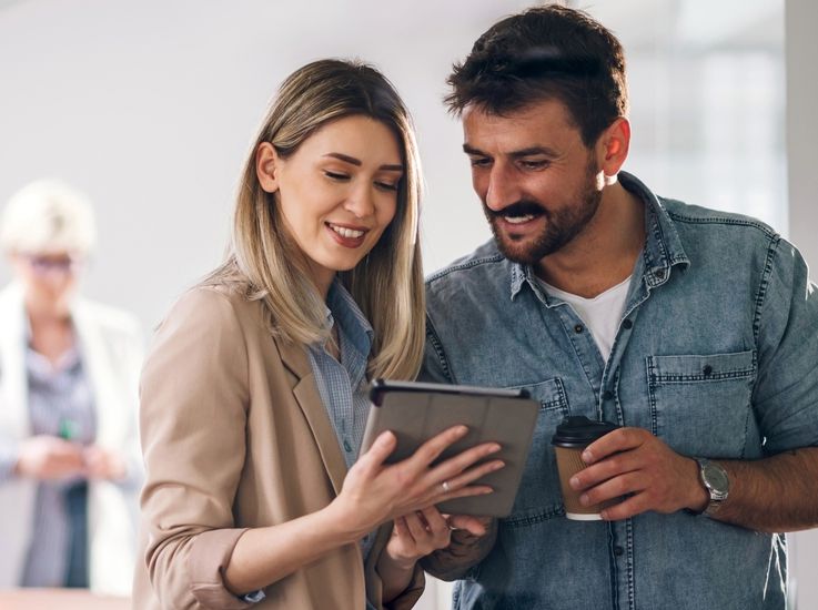Smiling couple looking at a tablet, illustrating a case study on finance outsourcing driving $3.5M in annual savings. Smiling couple looking at a tablet, illustrating a case study on finance outsourcing driving $3.5M in annual savings.