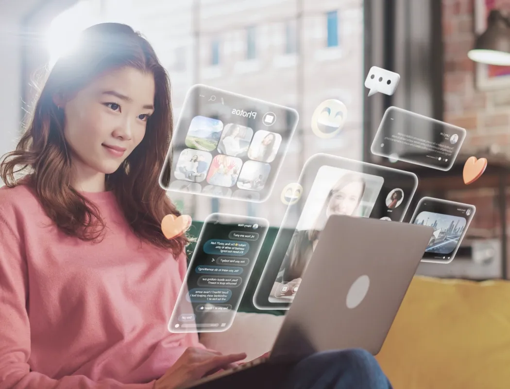 Young woman working on a laptop with overlaid screens, illustrating TP Interact advanced analytics platform.