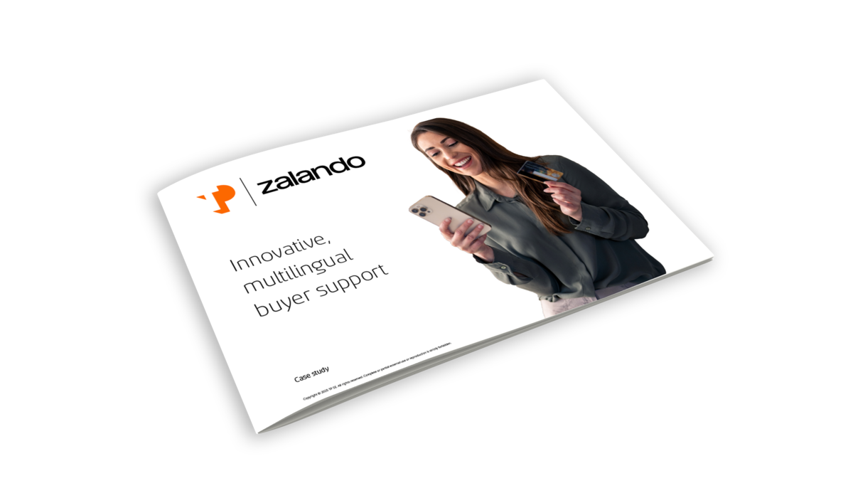 Smiling woman holding a credit card and cell phone, representing innovative, multilingual buyer support experiences.