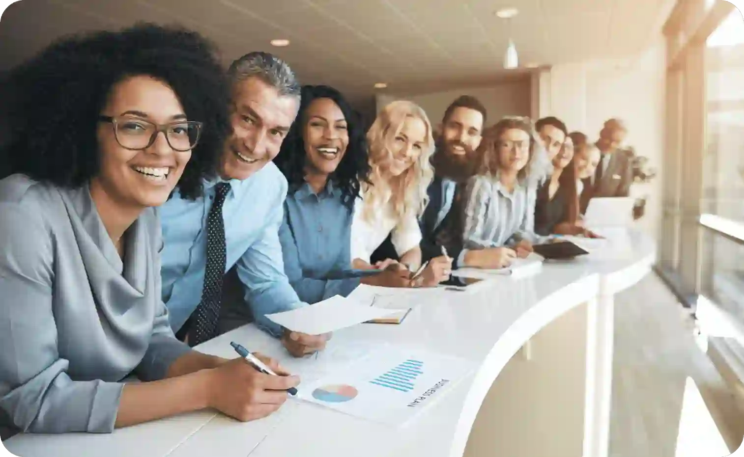 Diverse smiling group of employees in a row