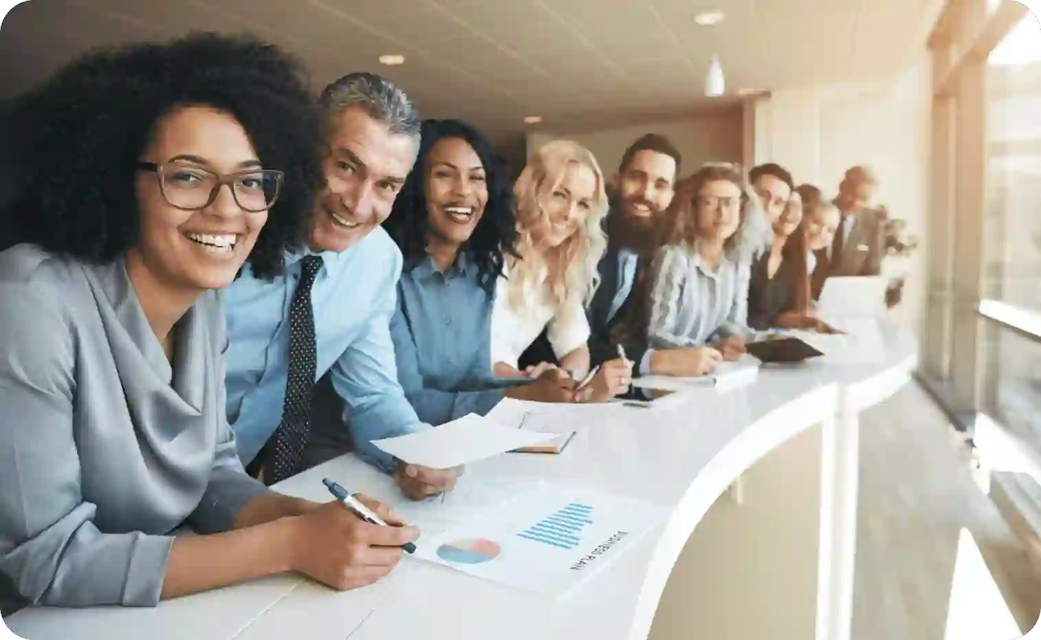 Diverse smiling group of employees in a row