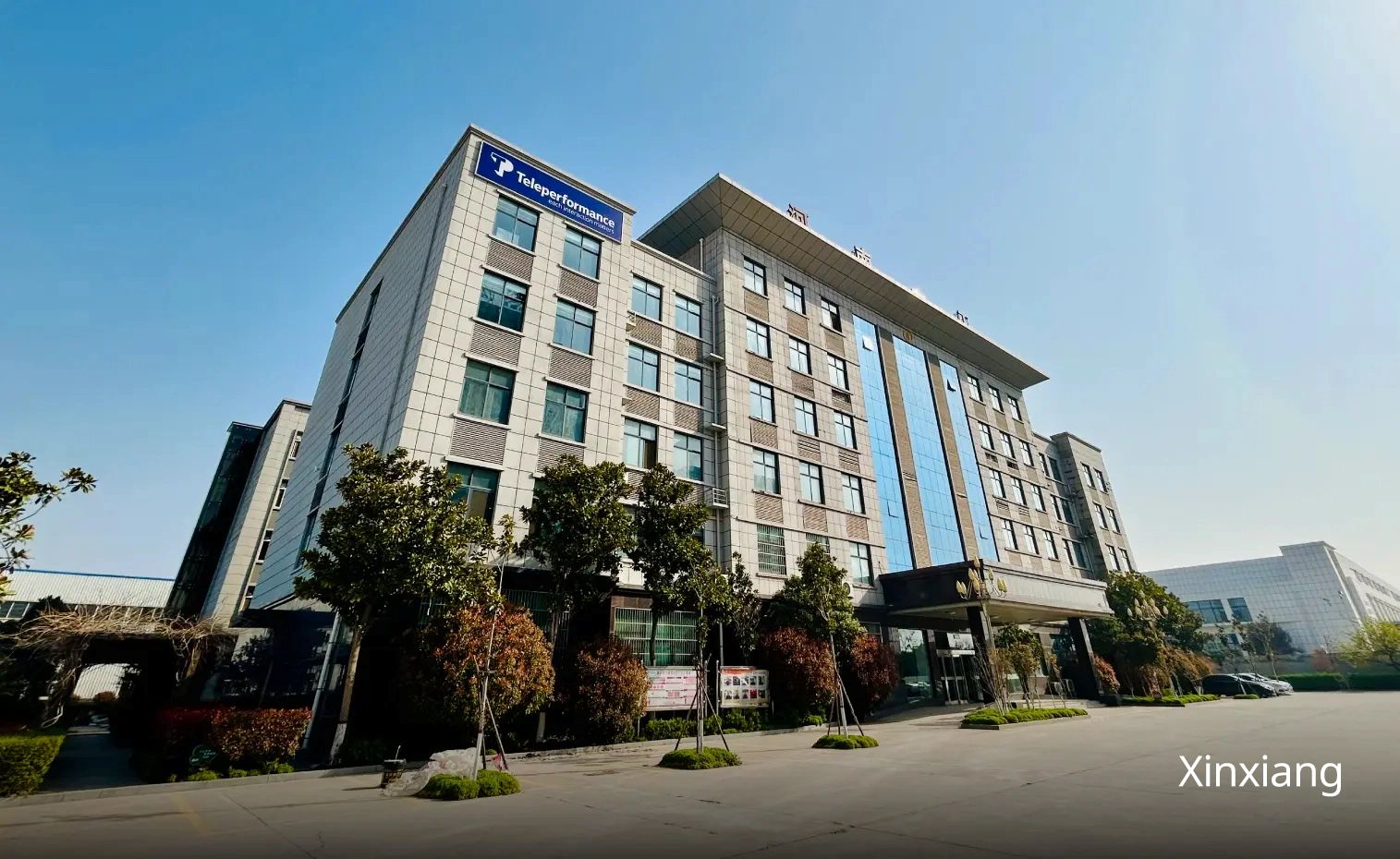 a building，have six floor，there is also a logo of TP  on the top of the building