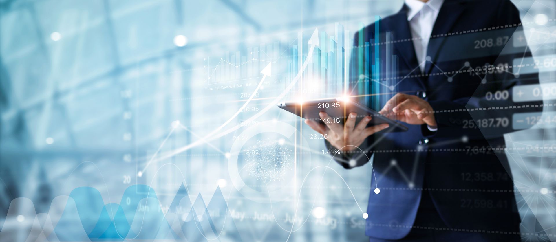 Business professional using tablet with digital financial graphs and data overlay.