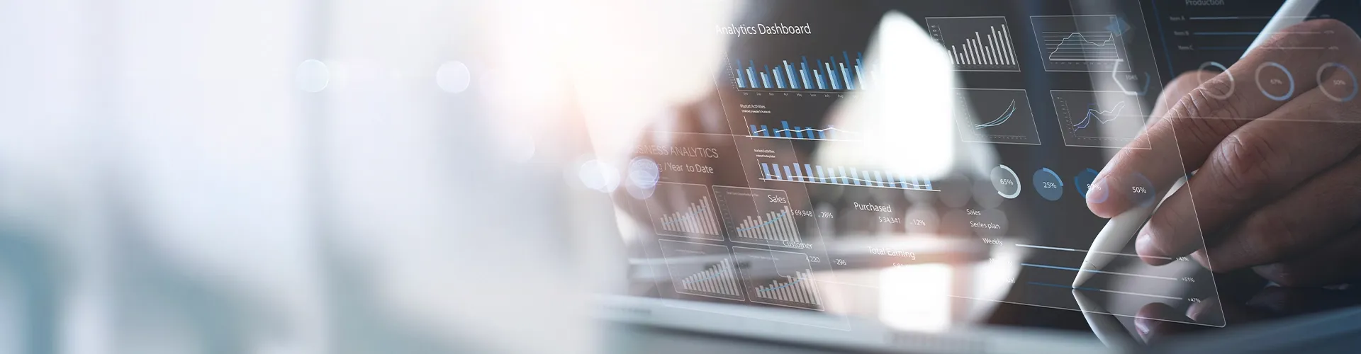 Person analyzing data on a transparent digital dashboard, highlighting analytics in a modern finance and accounting setting.