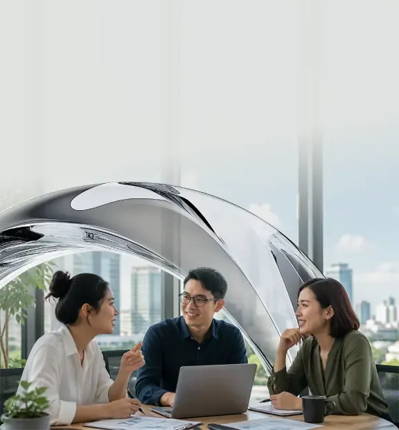 Three colleagues collaborate and discuss ideas in a bright modern office.