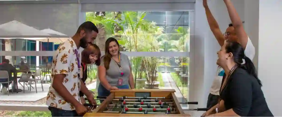 Brazilian employees have fun playing table football 