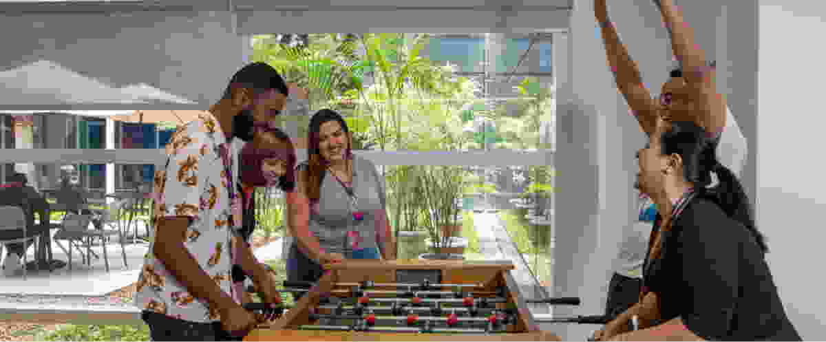 Brazilian employees have fun playing table football 