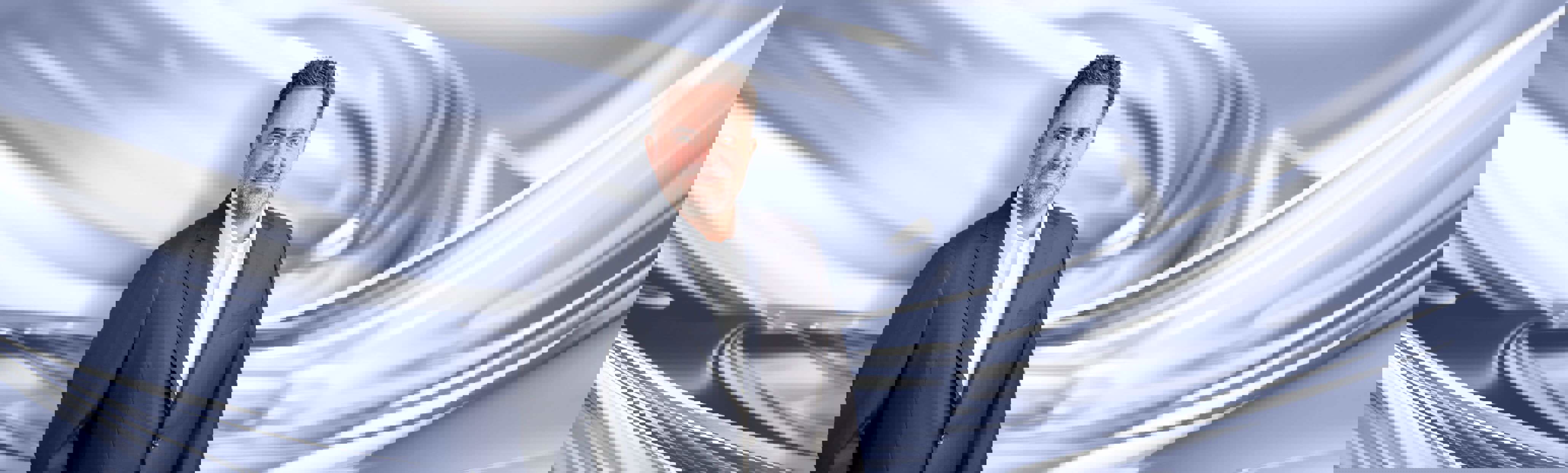 A man with dark color suit