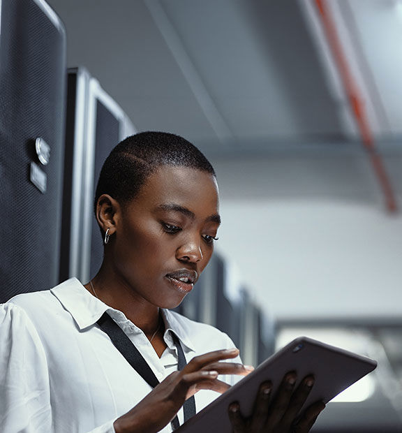 Afro descendant professional working in a modern data center environment.