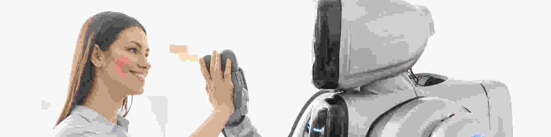 Woman handshaking a robot