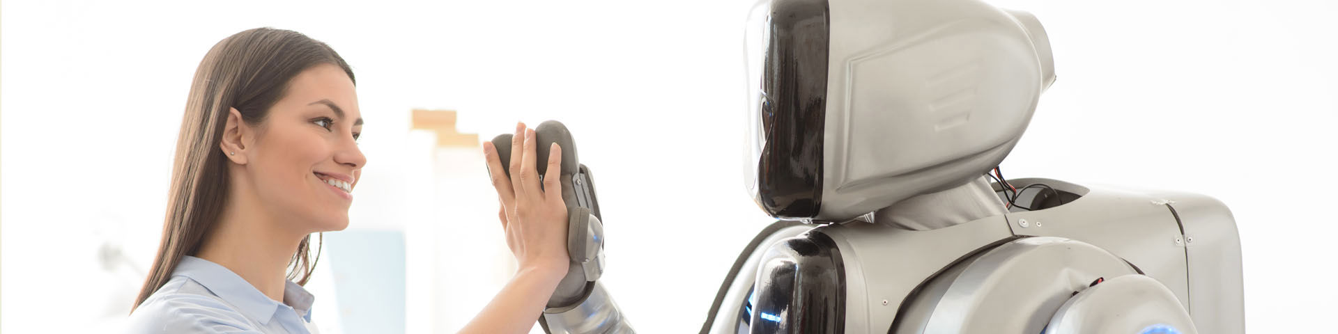 Woman handshaking a robot