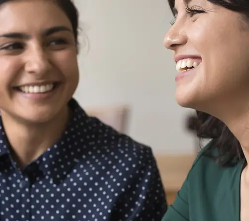 Two women conversing and smiling