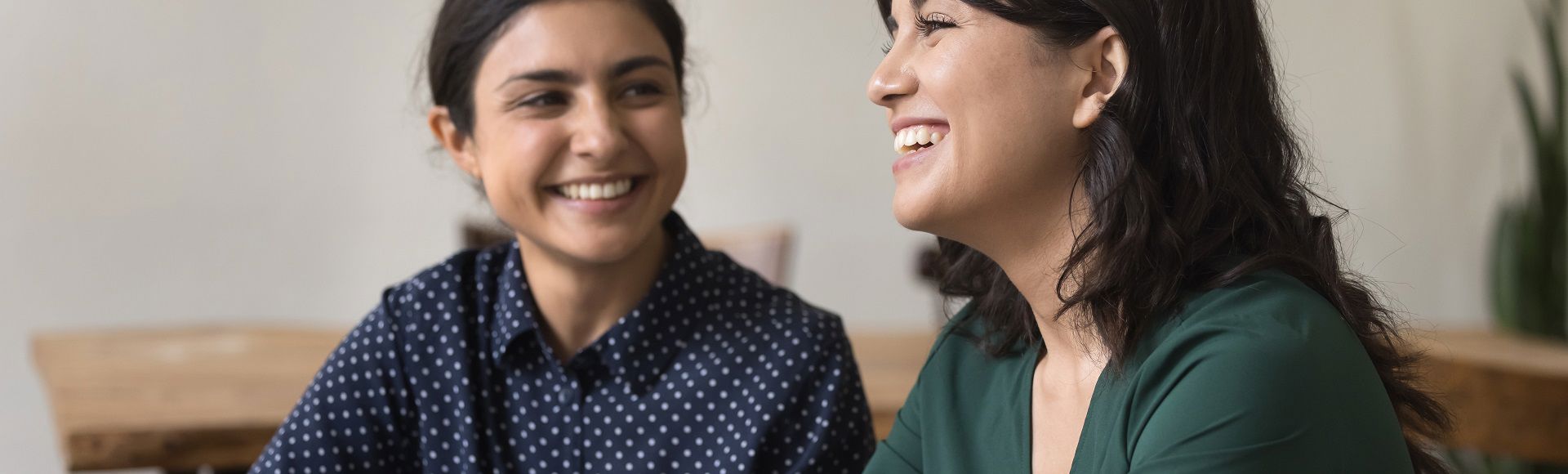 Two women conversing and smiling