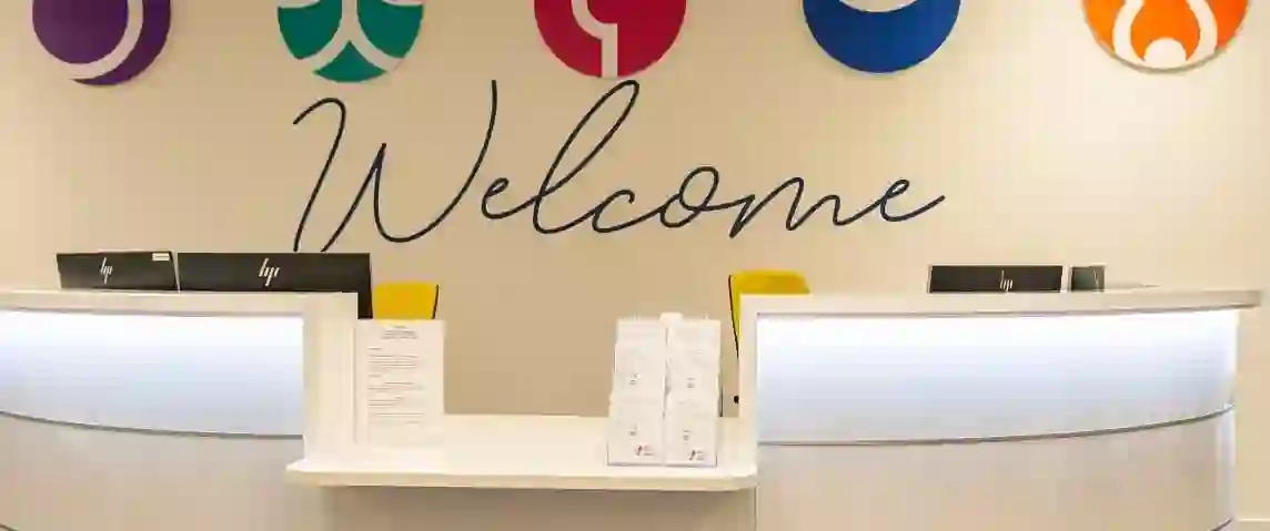 Reception desk in a TP UK building with a “Welcome” sign and TP values icons displayed on the wall behind.
