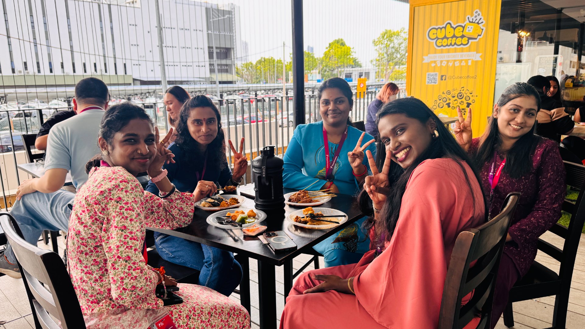 TP employees dining together at outdoor café table