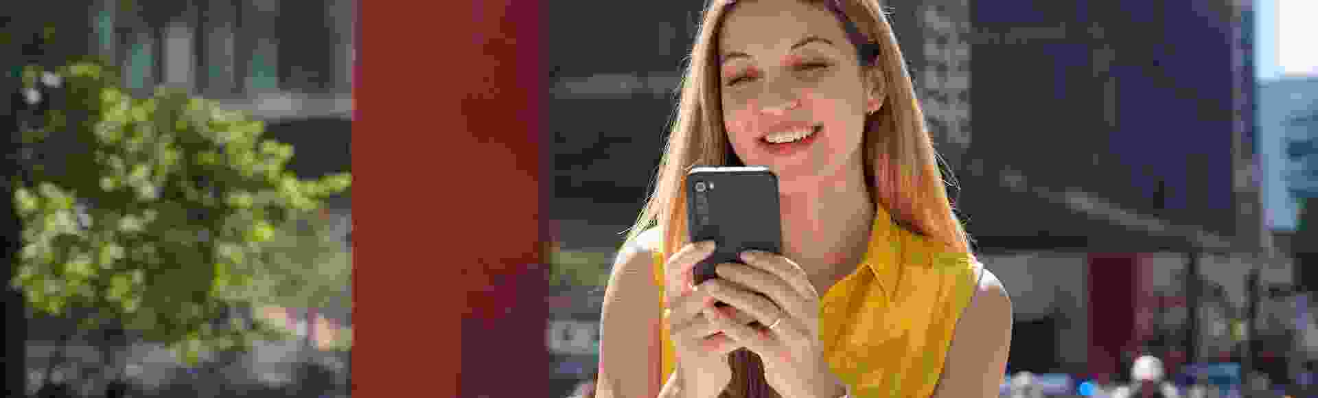 Woman browser cellphone on the street 