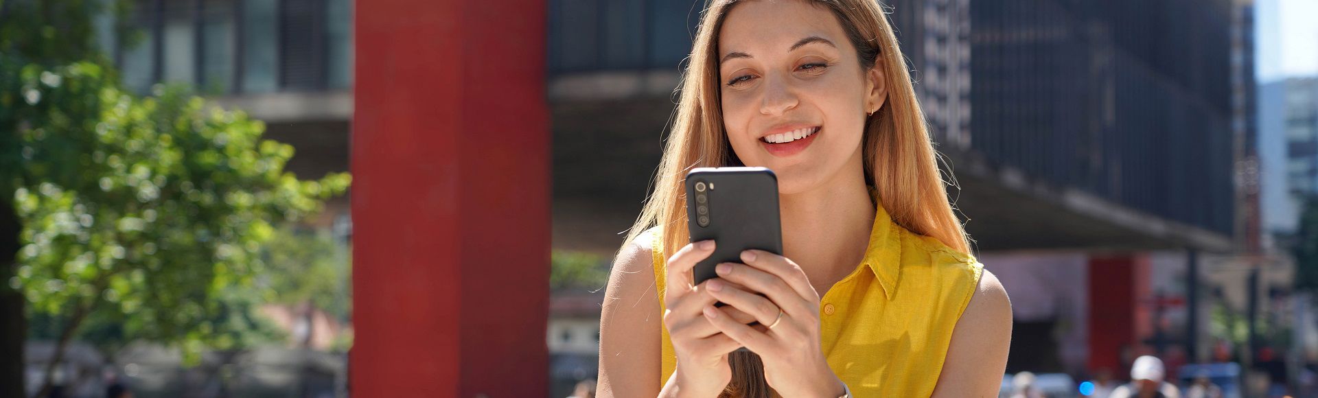 Woman browser cellphone on the street 