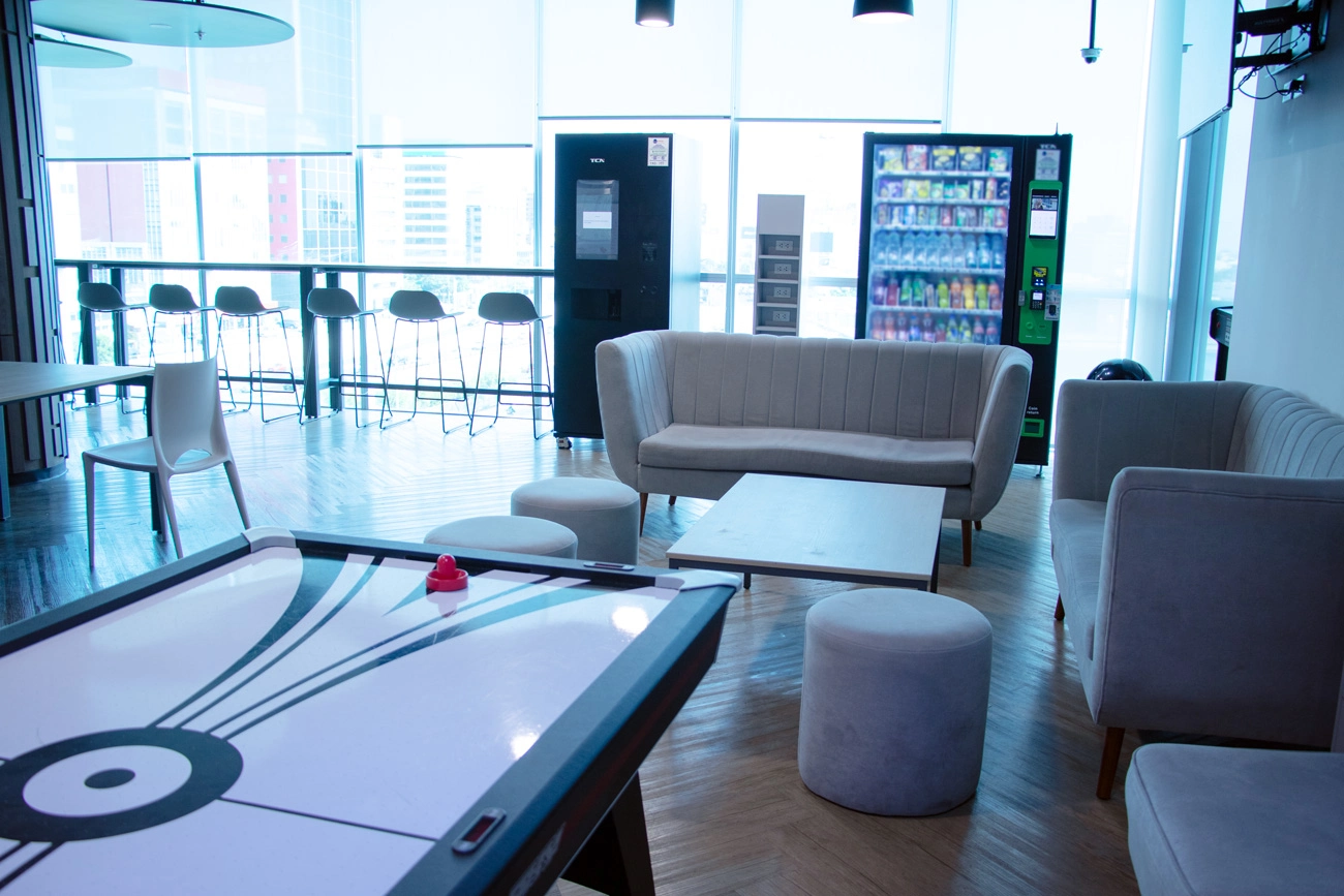 TP office lounge with sofas, vending machines and an air hockey table.