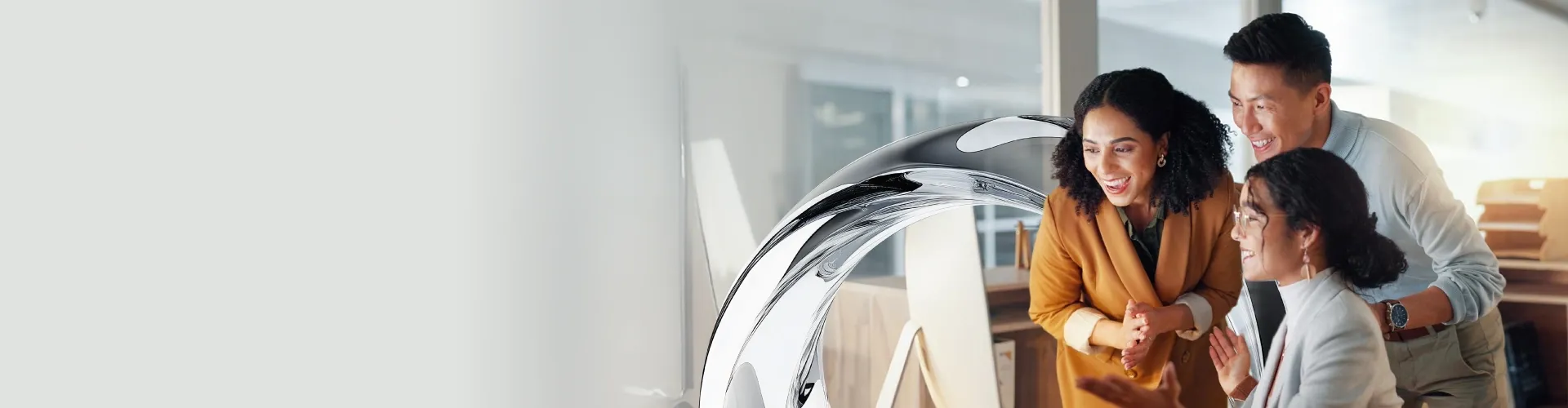 A diverse and cheerful business team celebrates a successful win together in a modern office, sharing joy and applause.