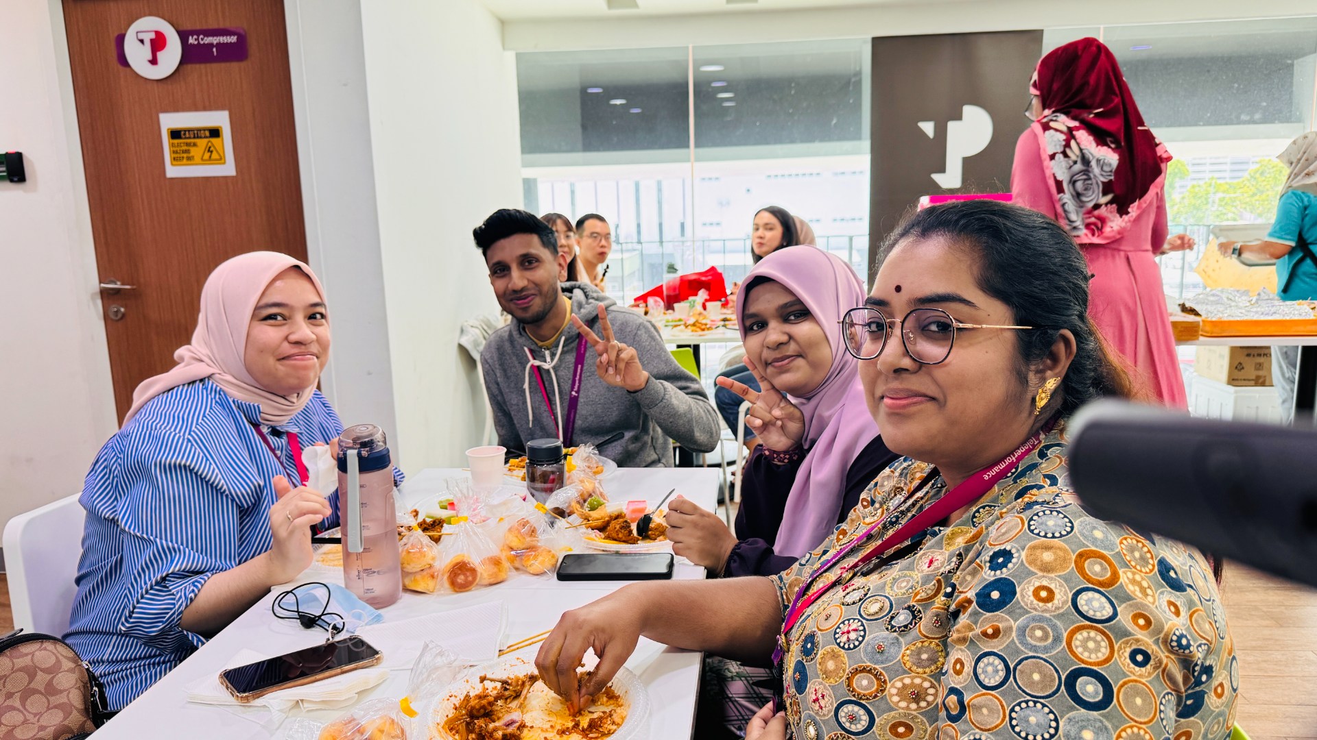 TP employees enjoying meal together in office cafeteria