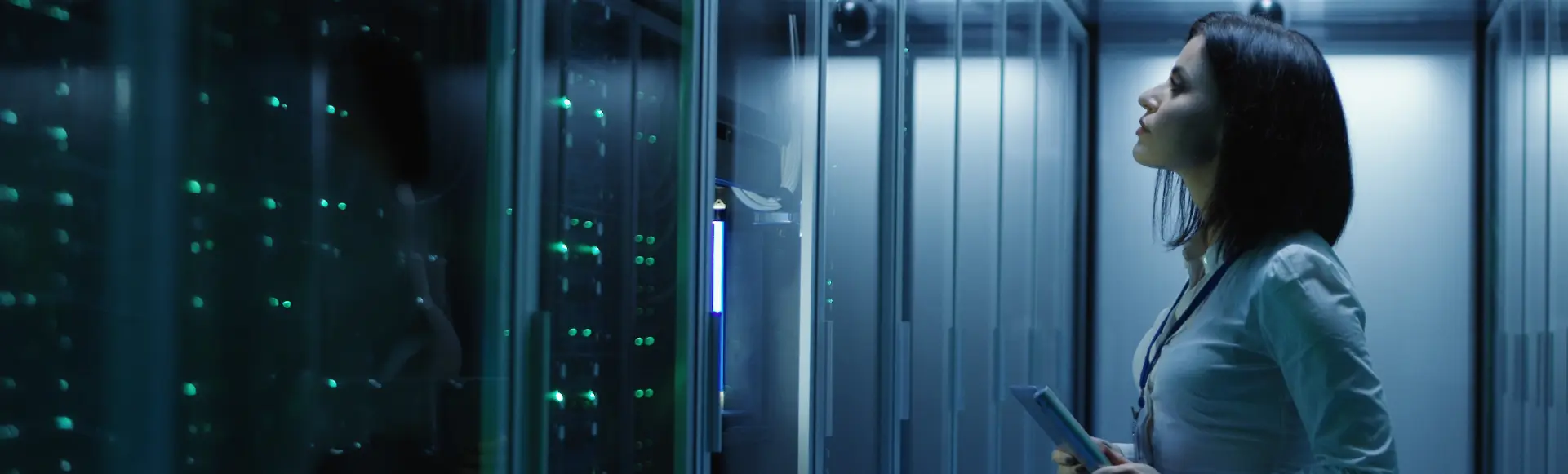 Professional reviewing AI infrastructure in a secure data center environment.