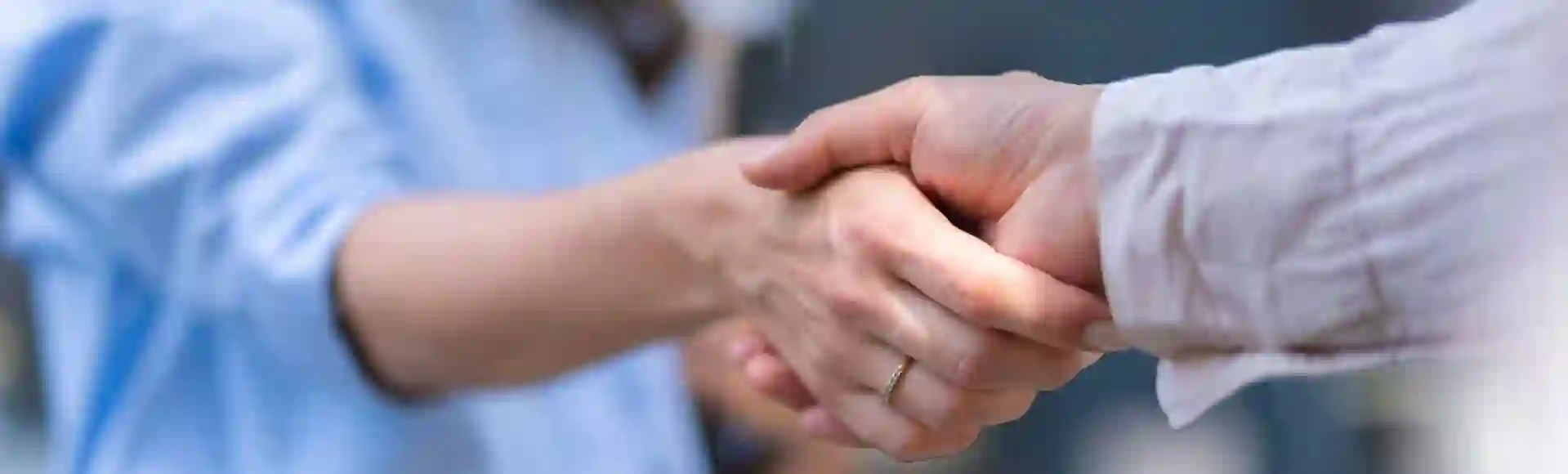 Businesspeople shaking hands, symbolizing partnership and successful collaboration.