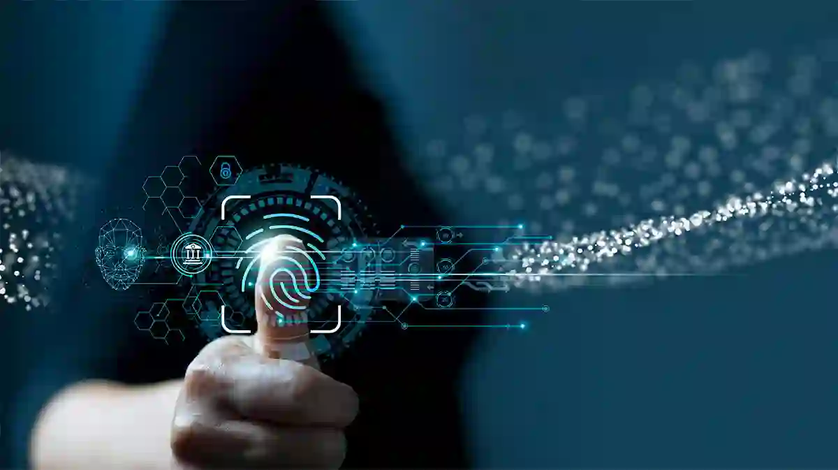 Person pressing their thumb on a digital biometric scanner with futuristic blue icons representing cybersecurity and digital identity.