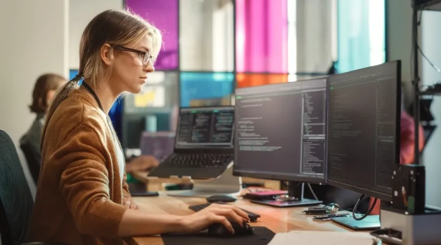 Woman developer working attentively at her computer.