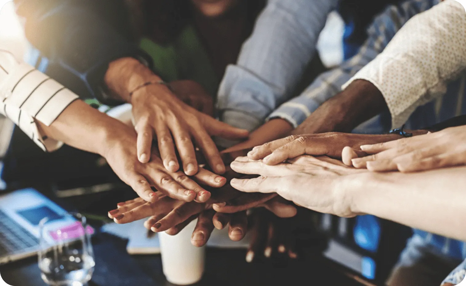 Stacked colleague's hands showing togetherness and collaboration on the team