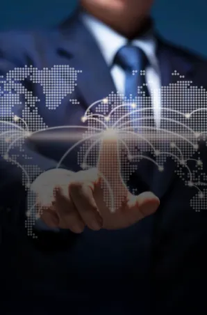 Business professional interacting with a global digital network map, symbolizing worldwide connectivity.