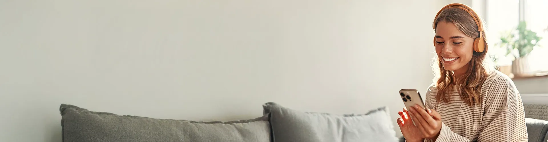 Smiling girl listening to music on her headphones