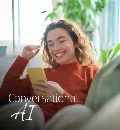 Smiling woman sitting comfortably on her sofa and browsing her cellphone