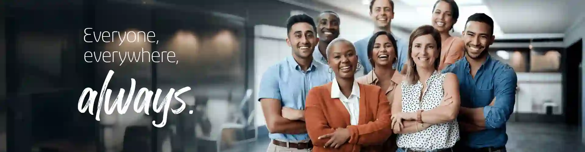 Smiling coworkers looking at the the camera while working in a modern office