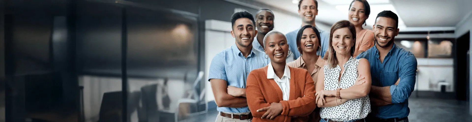 Smiling coworkers looking at the the camera while working in a modern office