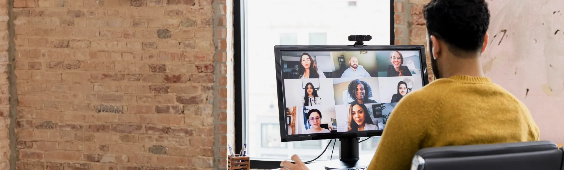 Professional joining a video call with colleagues from a home workspace.