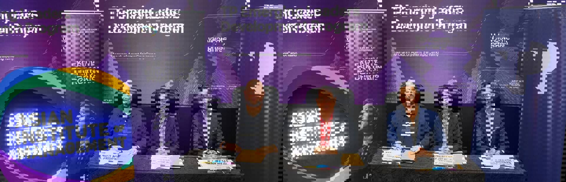 TP and AIM leadership formalizing the Emerging Leaders Development Program partnership.