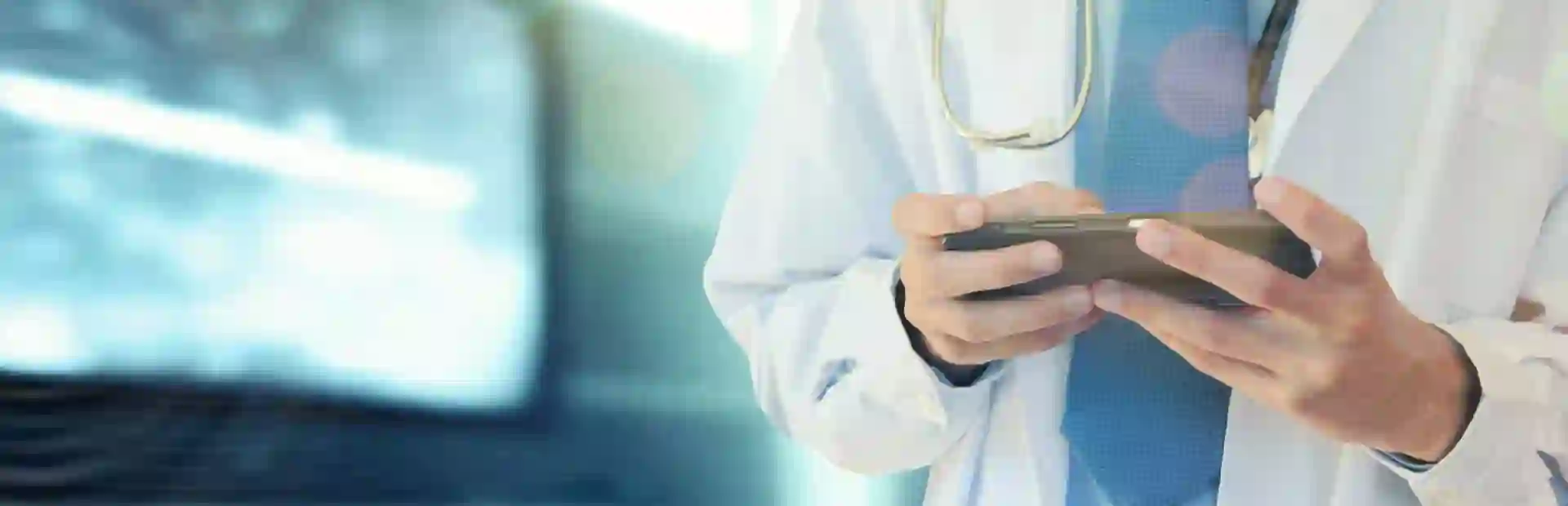Healthcare professional using a tablet to access patient or medical data.