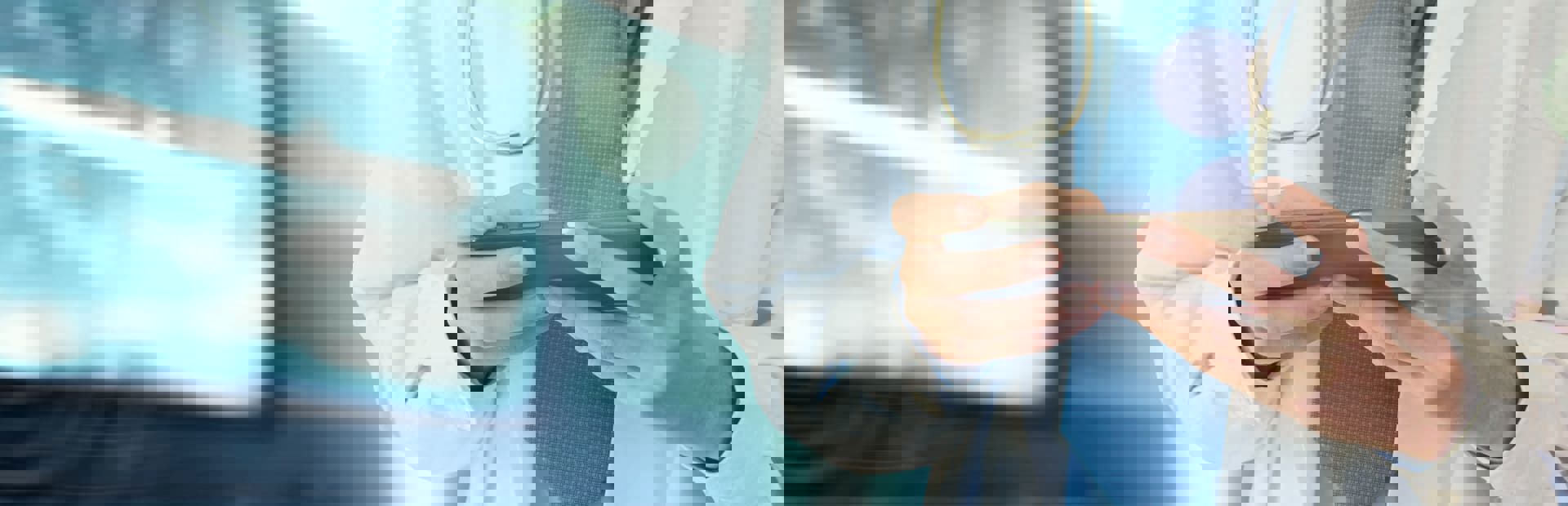 Healthcare professional using a tablet to access patient or medical data.