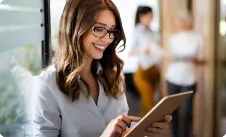 Smiling business woman working on his tablet