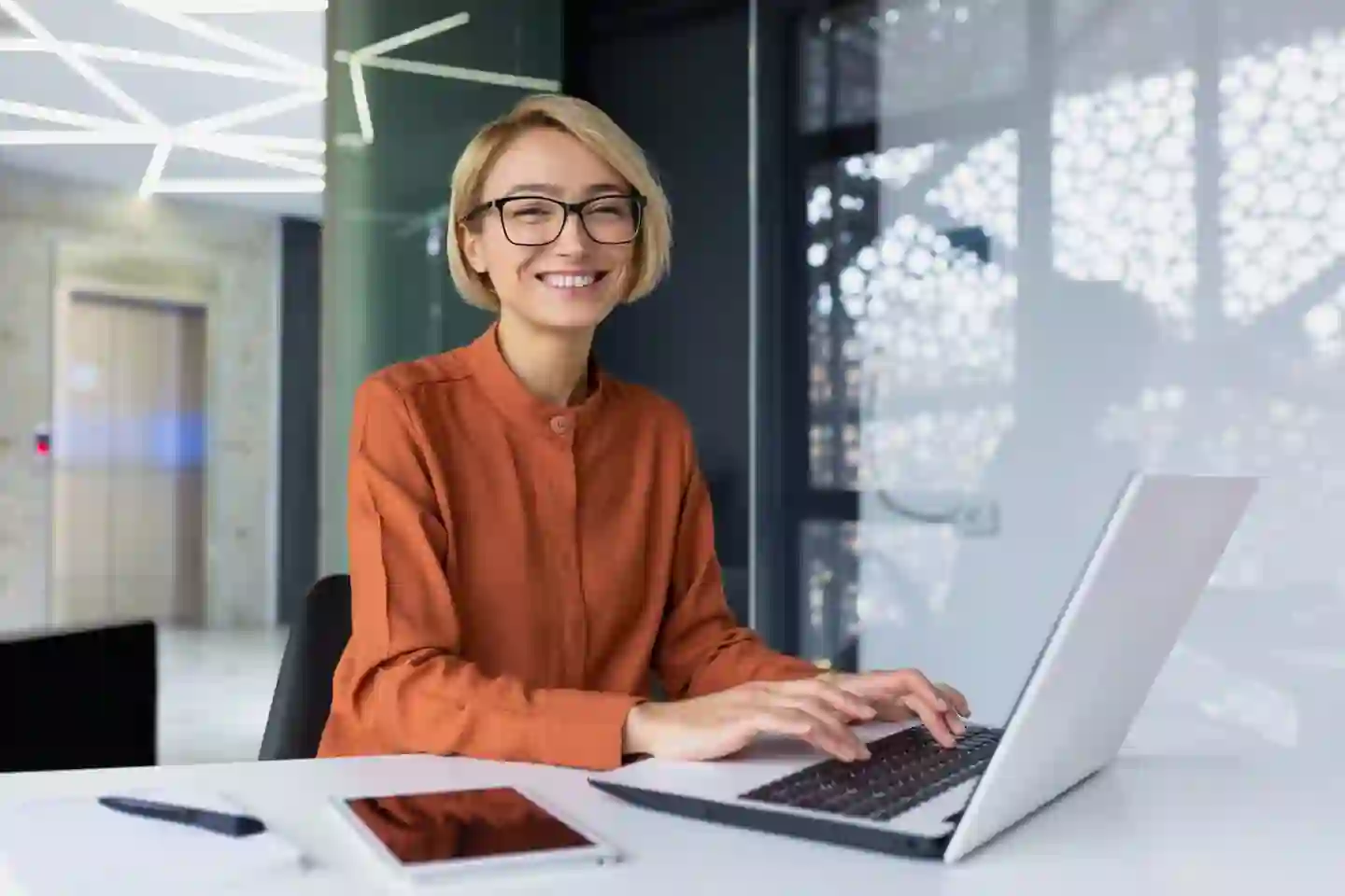 Smiling woman working on computer