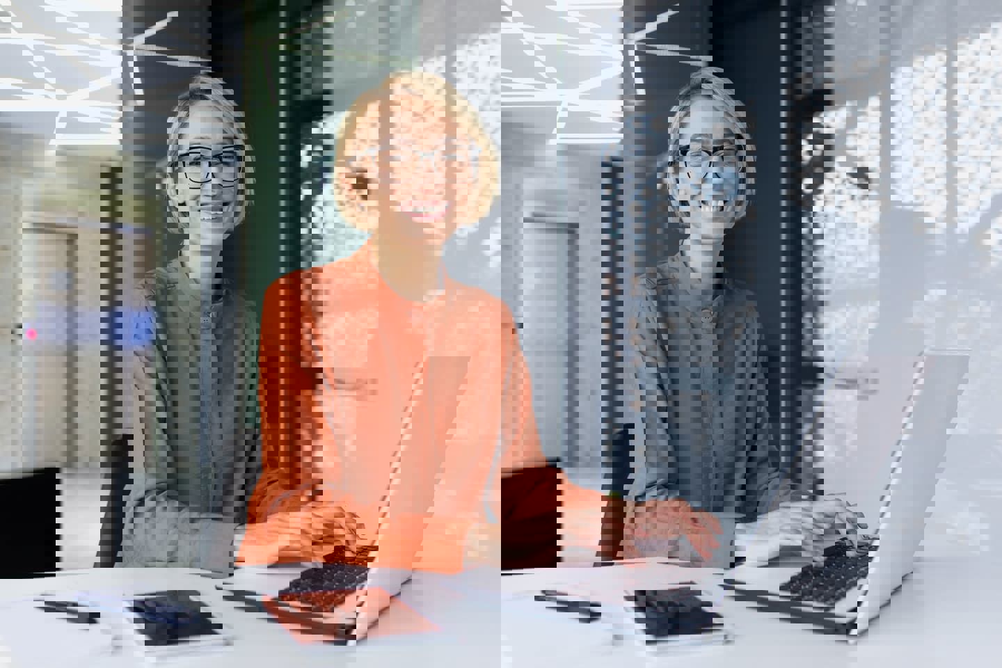 Smiling woman working on computer