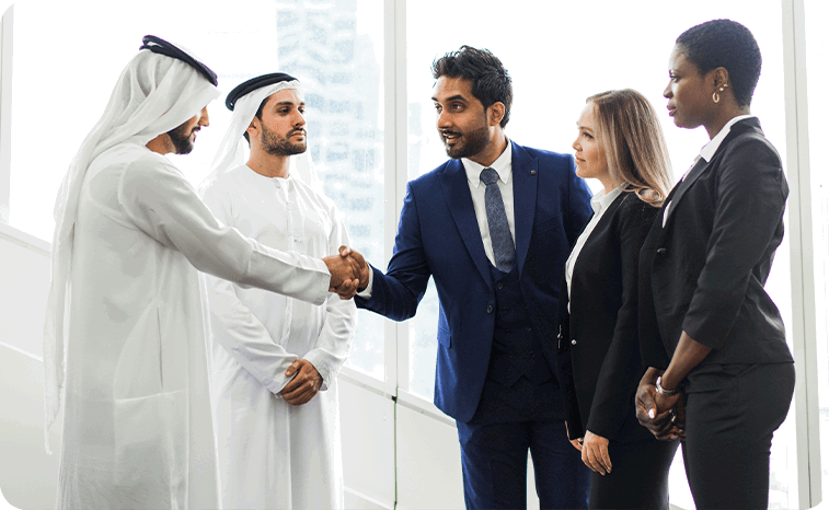 Cross-cultural business meeting with Middle Eastern and Western professionals in formal attire shaking hands in a modern office setting, symbolizing international collaboration and corporate partnership. Cross-cultural business meeting with Middle Eastern and Western professionals in formal attire shaking hands in a modern office setting, symbolizing international collaboration and corporate partnership.