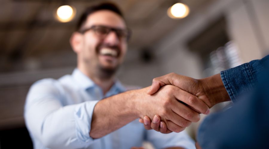 Shareholders greeting each other, reflecting partnership and business confidence.