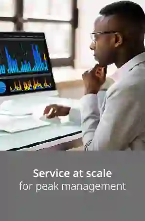 Serious man working on computer with his hand on his chin